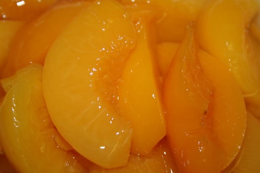 Close up of peaches in a sweet peach juice.
