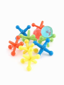 Colorful plastic toy jacks and balls isolated on a white background