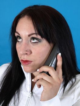 A woman rolls her eyes as she listens on the telephone.