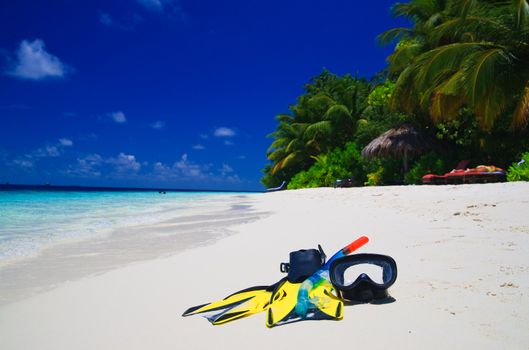 snorekl equipment on white sand beach at Maldives