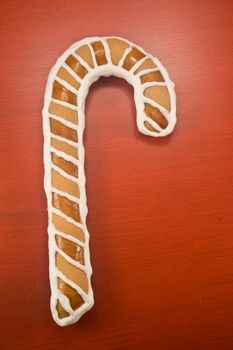 Candy cane cookie on red background