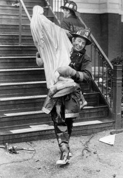 A firefighter carries a statue of Mother Mary out of the St. Patrick's Church in Stoneham, MA after a fire was put out in the Church. This picture was taken in 1977.