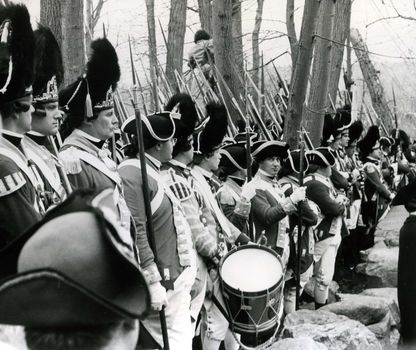 Photo was taken near the North Bridge in Concord, MA on April 19, 1975. These people were dressed in old Patriot military uniform and were part of a crowd estimated at 110,000 gathered to view a parade and celebrate the Bicentennial. President Gerald Ford delivered a major speech near the Concord North Bridge to this crowd.