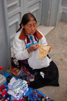 Old Mayan Woman selling shirts on the street