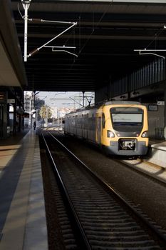 Lonely person waiting for a train at large station