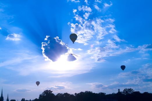 three ballon on cloudy sky