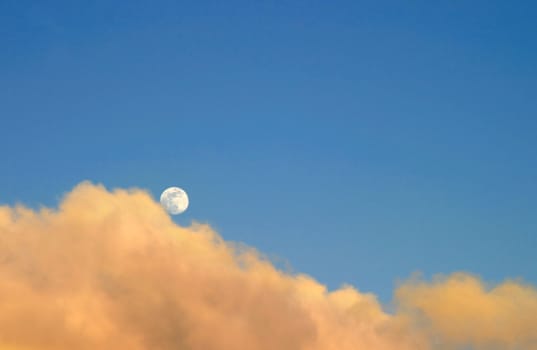Moon at sunset with clouds
