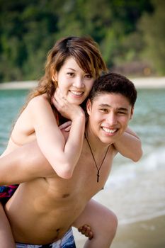 happy young couple by the beach