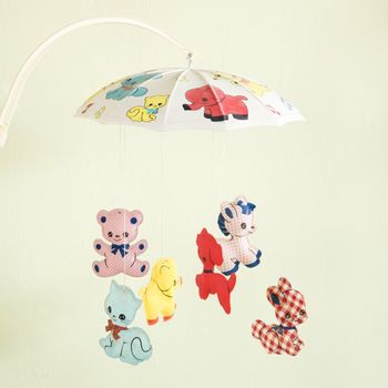 Still life of vintage baby mobile with colorful moving animals.