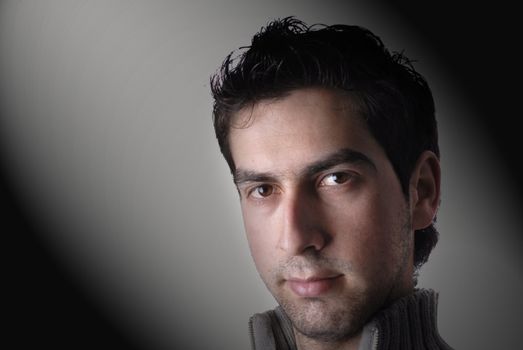 young casual man portrait in a black background