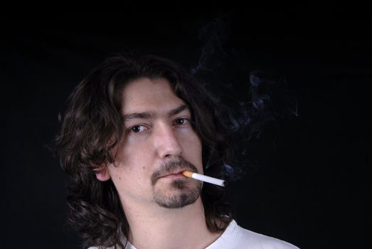 casual young man portrait posing with cigarette