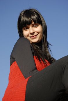 casual latin girl outdoors with the sky in the background