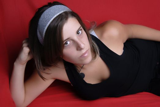 young girl in a sofa, studio picture