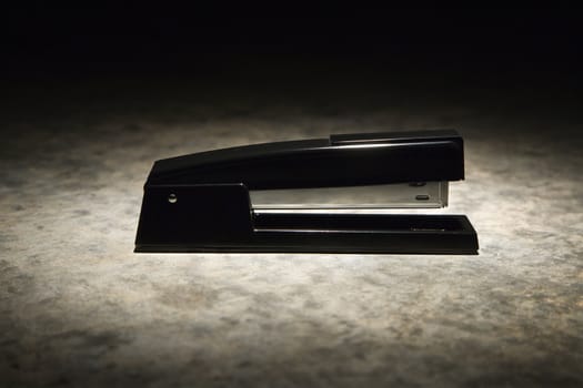 Black stapler with black vignette.