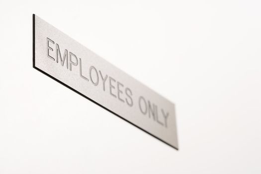 Selective focus of employees only sign.