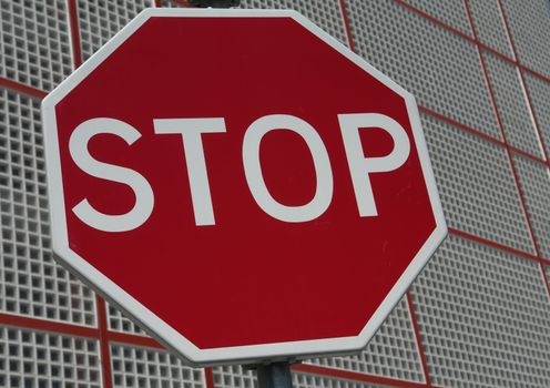 red stop sign with a new building in the back