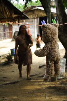 This teddy bear was hanging, drying in the middle of an indian tribe in the Amazon.