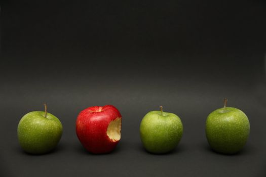 A line of apples with one exception.