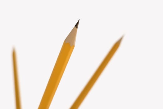 Three pencils pointing in air with selective focus.