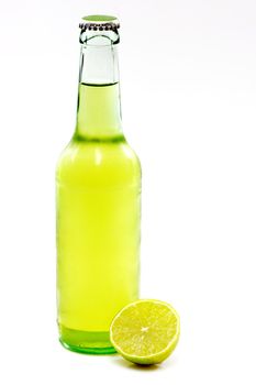 A bottle of lime beer with lime slice on white background