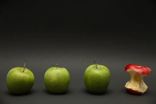 A line of apples with one exception.