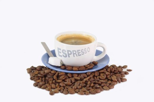 Expresso coffee with sugar over roasted coffee beans.
