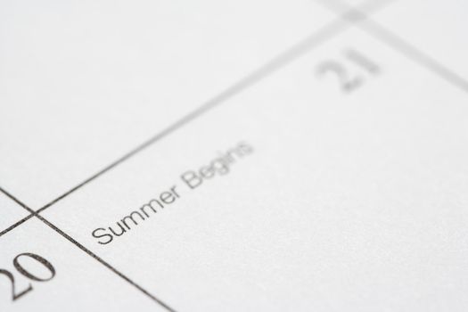 Close up of calendar displaying the beginning of summer.