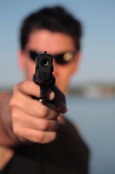 A man holding a pistol and pointing it at the camera. (This image is part of a series).

[b]PS: I'd LOVE it if you'd sitemail me to let me know how/where this image is being used! :) Cheers! ;)[/b]