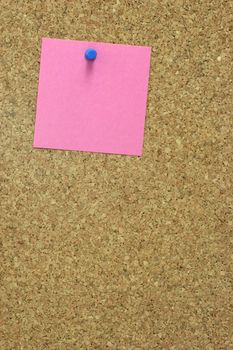  Colorful blank post it note affixed to the corkboard.
