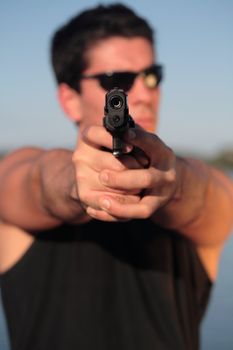 A man holding a pistol and pointing it at the camera. (This image is part of a series).

[b]PS: I'd LOVE it if you'd sitemail me to let me know how/where this image is being used! :) Cheers! ;)[/b]