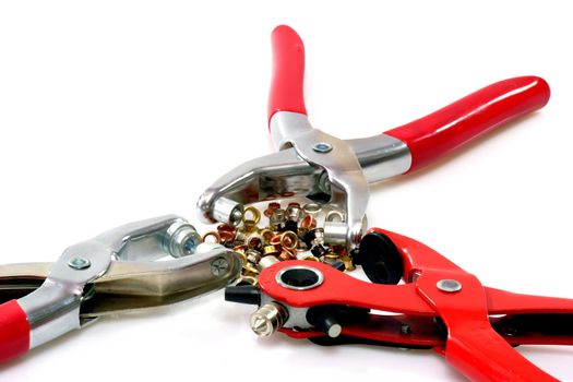 Three rivetter tools with metal chinch on bright background.
