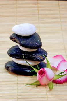 Some stones arranged on a wooden mat.