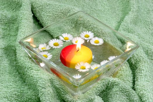 Candle with Flowers swimming in a bowl of water

