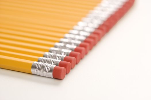 Eraser ends of group of pencils lined up in an even row.