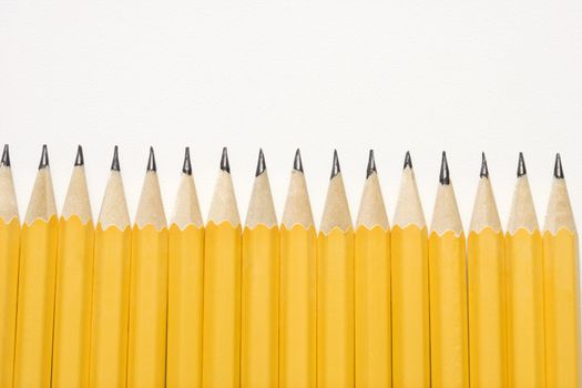 Sharp pencils lined up in an even row.
