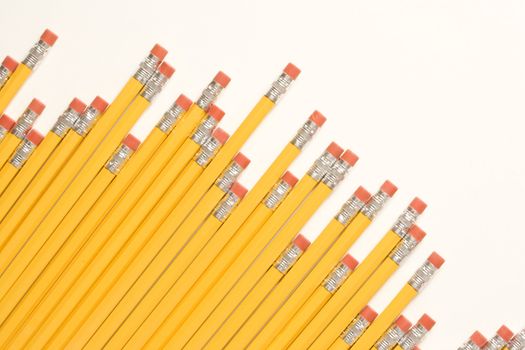 Uneven diagonal row of eraser ends of pencils.