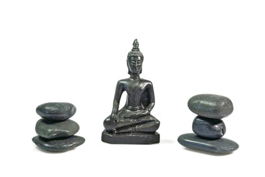 Black buddha statue with black stones on white background