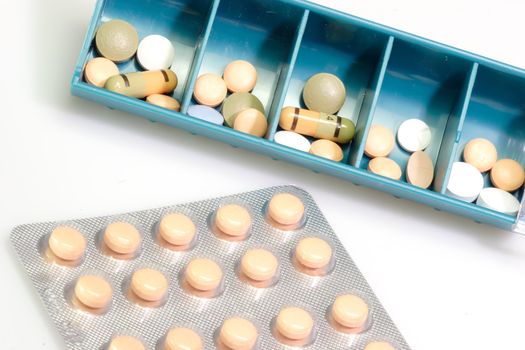 Pill boxes indicating days of the day with pills  on bright Background
