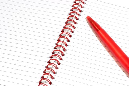Close up of a red notepad with ballpen