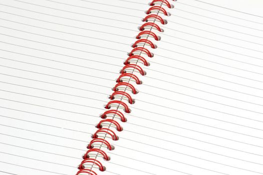 Close up of a ringbound red notepad