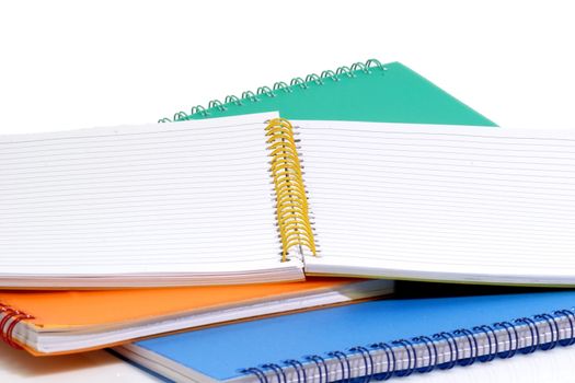 A stack of colored booklets on bright background