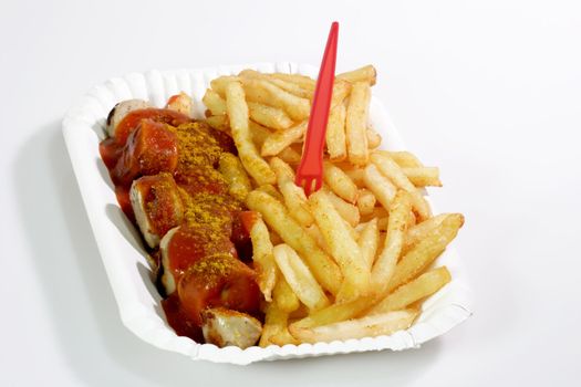 German sausage with ketchup and french fries on bright background