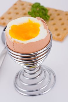 brown egg in an eggcup and crispbread