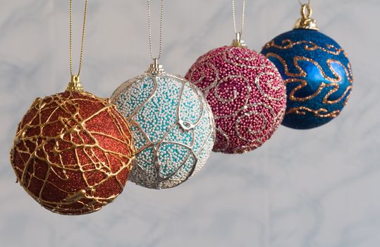 Four handicraft christmas balls. Focus on second ball.
