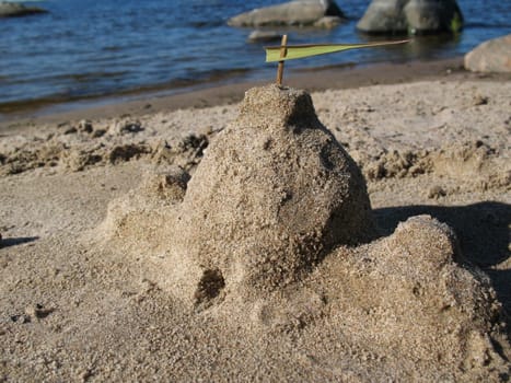 Castle made of sand on lake beach