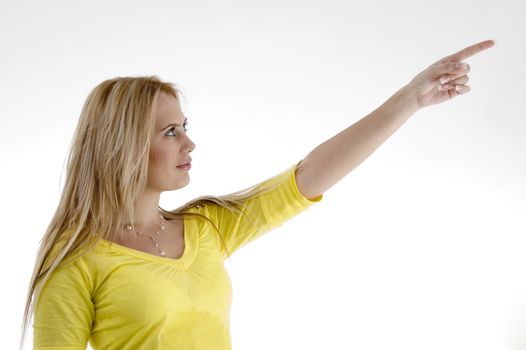 smiling woman pointing side on an isolated white background