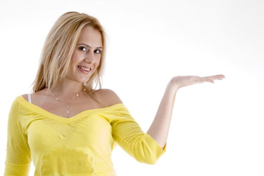 smiling woman with open palm against white background