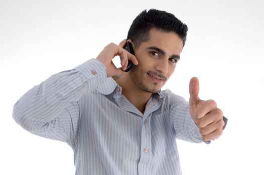 man talking on cell phone and wishing goodluck on an isolated white background