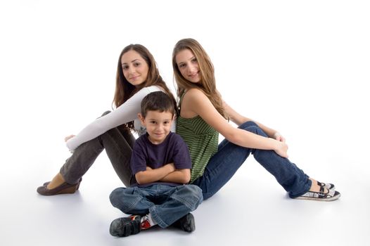 young kid sitting with teenagers on an isolated white background