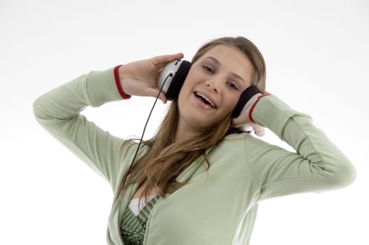 attractive female enjoying music isolated with white background